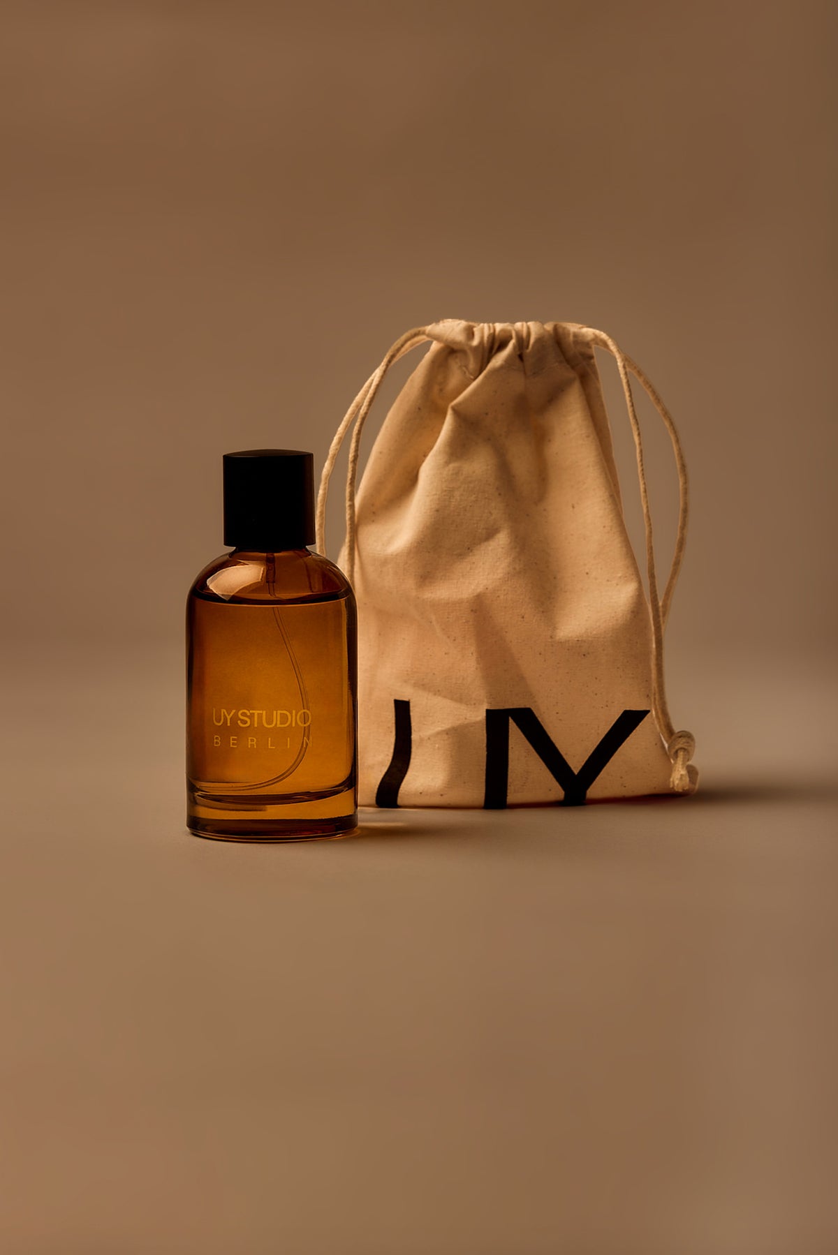 UY Studio X unisex room spray 100 ml amber glass bottle with engraved logo and black cap, Patchouli, Sandalwood, Agarwood, Tonka bean