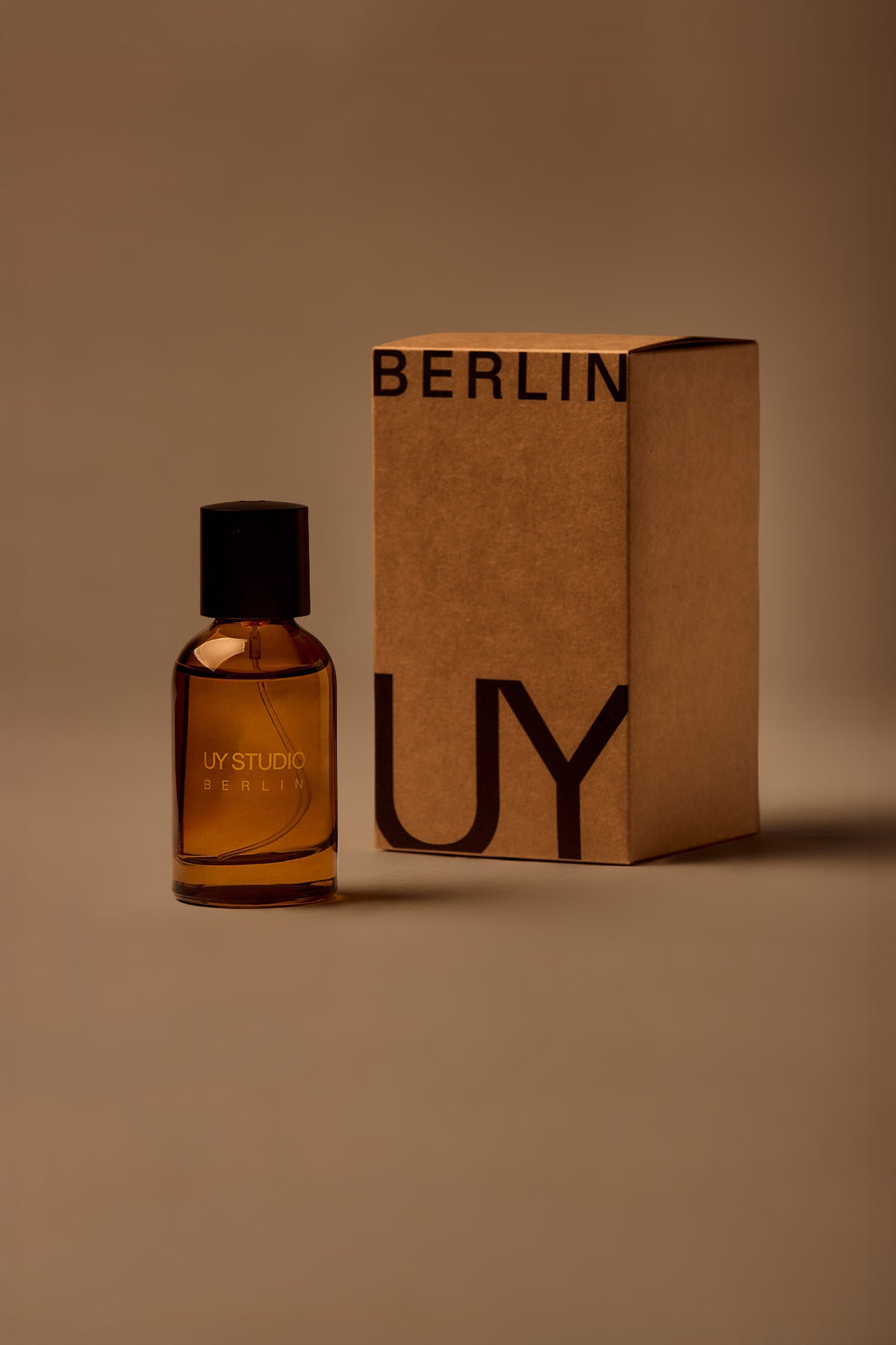 UY Studio T unisex eau de parfum, 50 ml amber glass bottle with engraved logo and black cap, rose, cedar, black tea, musk