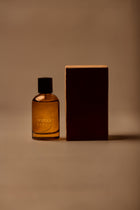 UY Studio X unisex room spray 100 ml amber glass bottle with engraved logo and black cap, Patchouli, Sandalwood, Agarwood, Tonka bean