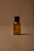 UY Studio T unisex eau de parfum, 50 ml amber glass bottle with engraved logo and black cap, rose, cedar, black tea, musk