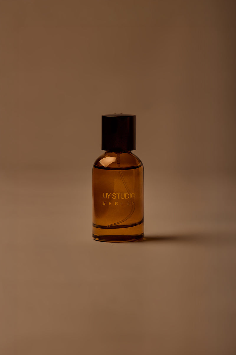 UY Studio T unisex eau de parfum, 50 ml amber glass bottle with engraved logo and black cap, rose, cedar, black tea, musk
