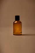 UY Studio X unisex room spray 100 ml amber glass bottle with engraved logo and black cap, Patchouli, Sandalwood, Agarwood, Tonka bean