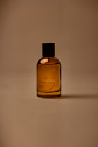 UY Studio X unisex room spray 100 ml amber glass bottle with engraved logo and black cap, Patchouli, Sandalwood, Agarwood, Tonka bean