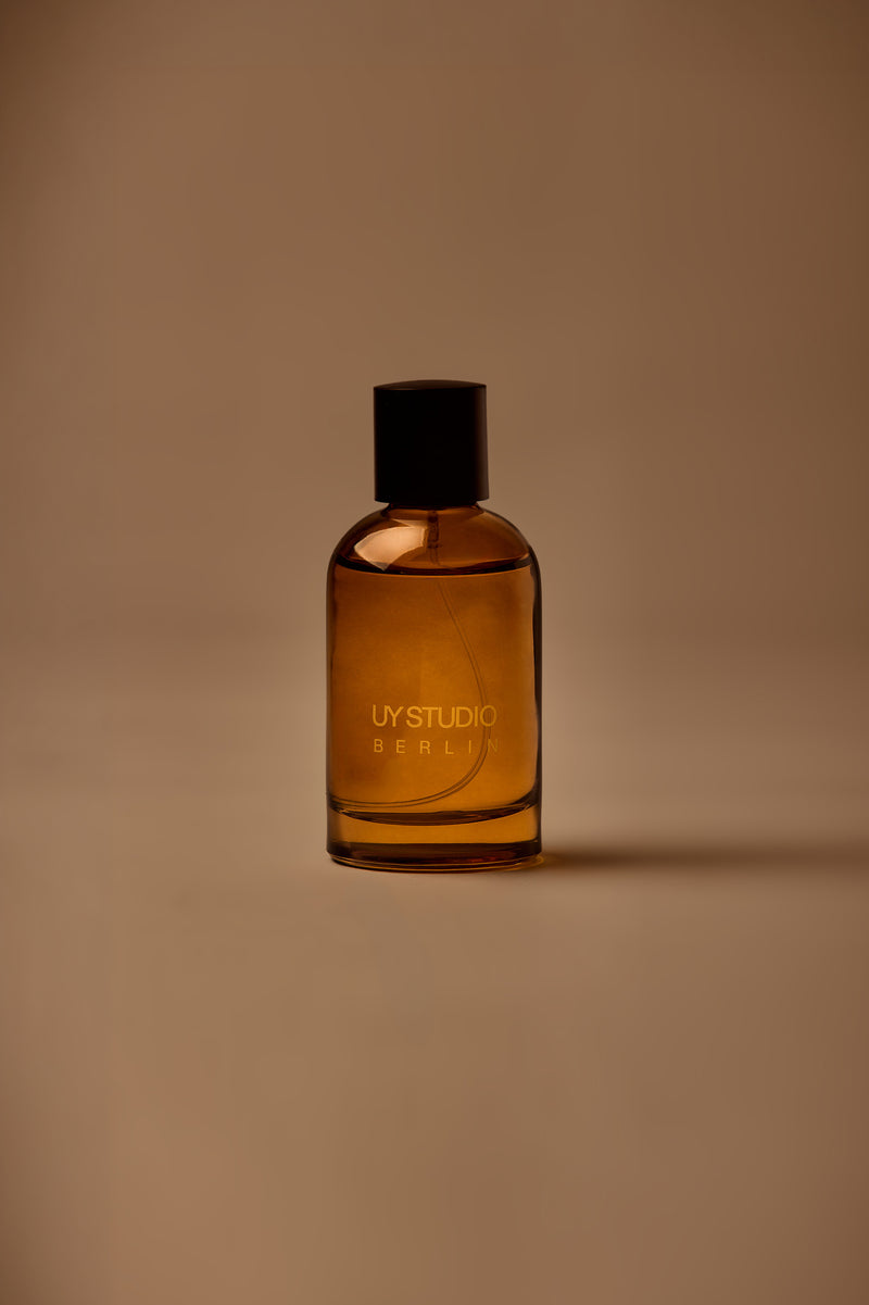 UY Studio X unisex room spray 100 ml amber glass bottle with engraved logo and black cap, Patchouli, Sandalwood, Agarwood, Tonka bean